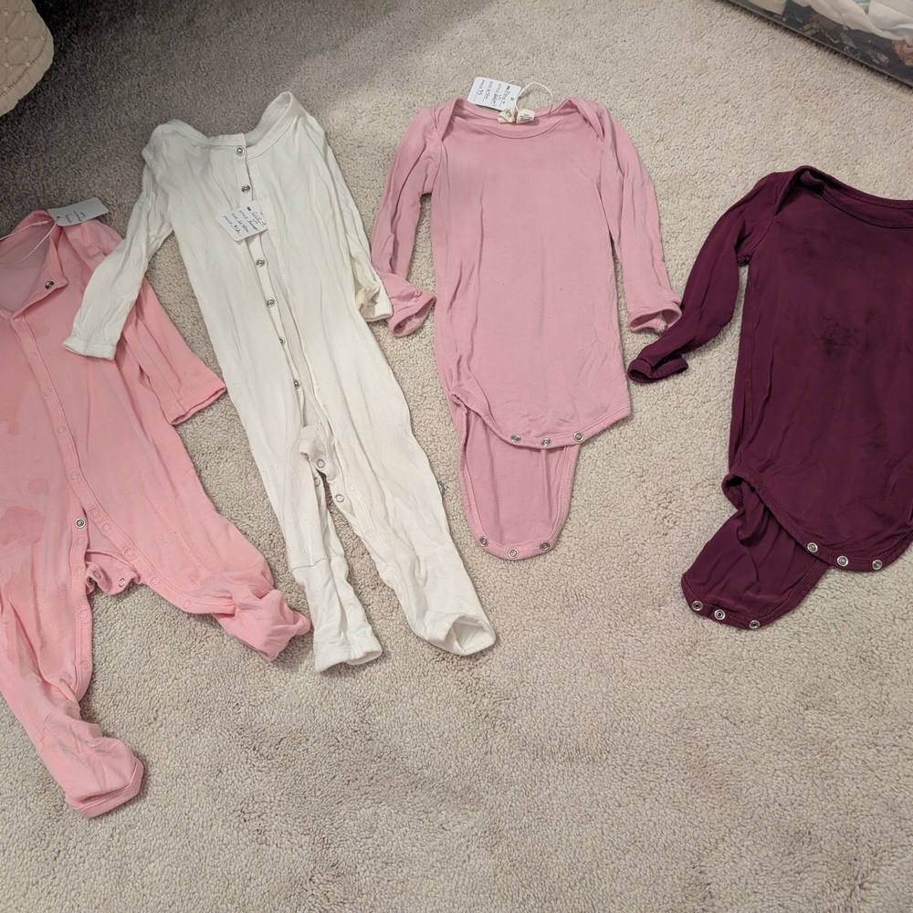 Set of Four Baby Onesies in Pink, Cream, and Purple
